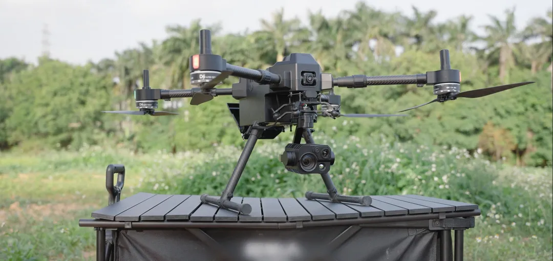 SIYI ZT30 multi-sensor optical pod being mounted on UniDrone E900 industrial multi-rotor UAV with anti-vibration quick-release system