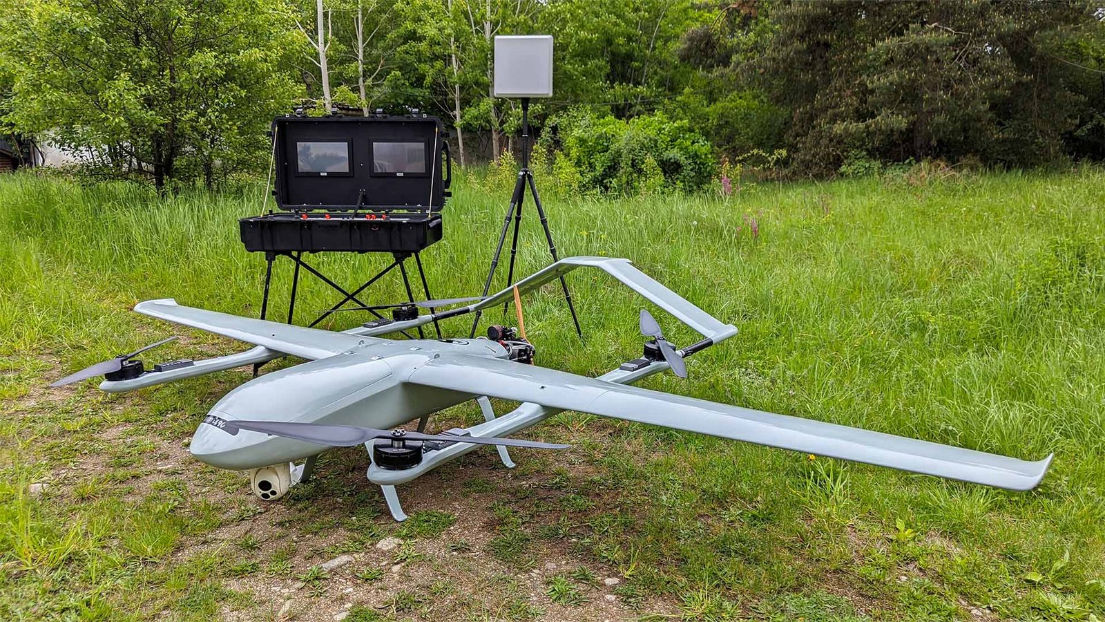 ATS Special automatic antenna tracking system ground station locking onto a long-range UAV, showing motorized pan-tilt gimbal and high-gain data link antenna